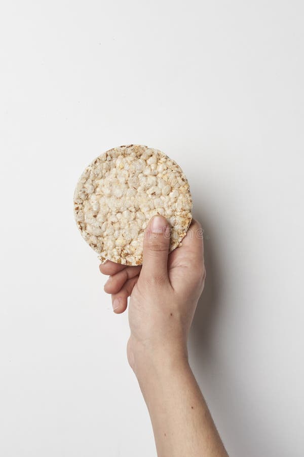 Hand holds rice cake. stock image. Image of breakfast 249677723