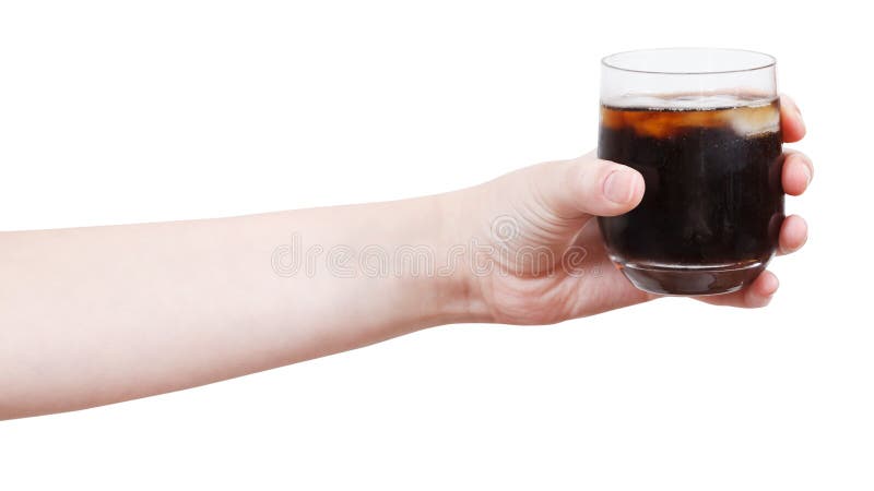 Hand holds soft drink with ice in glass