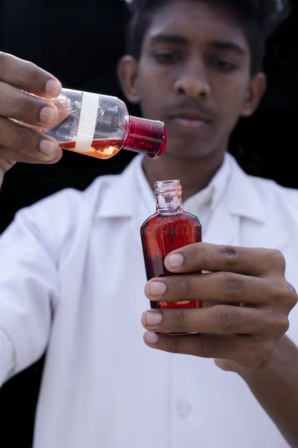 Laboratory Technician Or Doctor Hand Holds A Test Bottle Containing A Laboratory Technician Or Doctor Hand Holds A Test Bottle Containing A