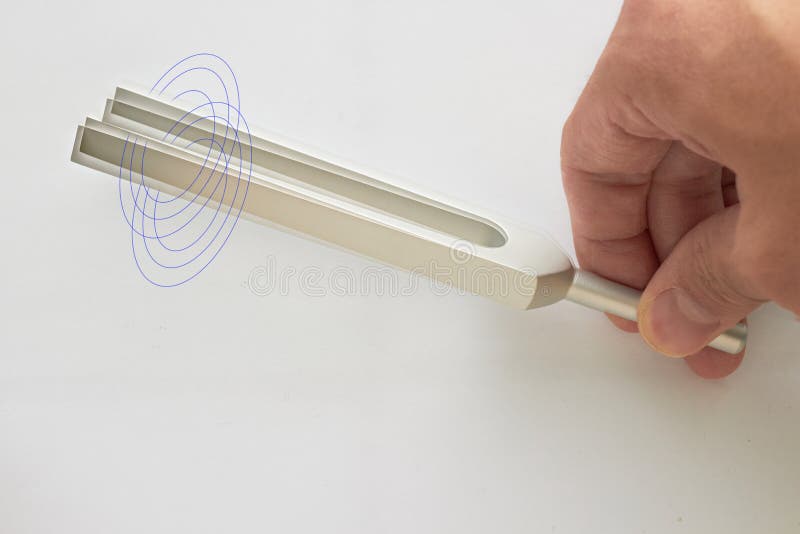 Hand holds Tuning fork for ear test of ENT doctor or sound wave maker on white background with double exposure stock images Hand holds Tuning fork for ear test of ENT doctor or sound wave maker on white background with double exposure stock images