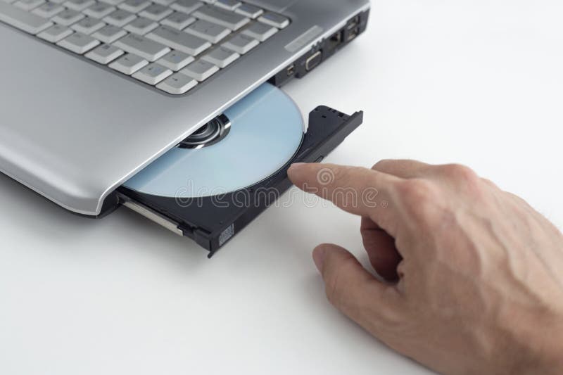 Hand Inserts Dvd Disc into Laptop, Concept of Burning Data To Dvd Stock