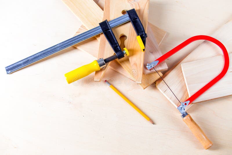 Hand Jigsaw, Wood and Clamps are on the Table Stock Photo Image of
