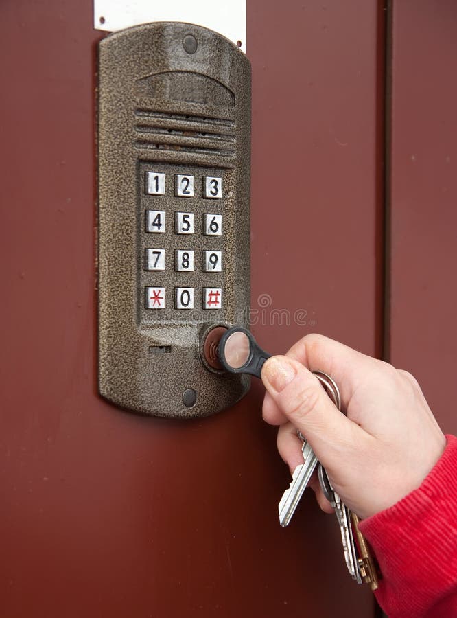 Hand with keys near intercom royalty free stock image