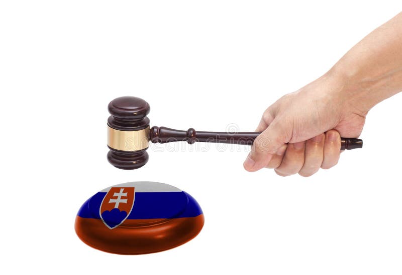 Hand knocking a Judge gavel at soundboard with Slovakia flag