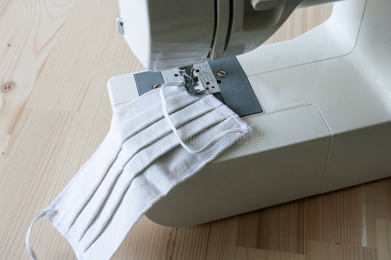 Hand made mask, sew at home, sewing machine. Protective clothing against coronavirus royalty free stock images Hand made mask, sew at home, sewing machine. Protective clothing against coronavirus royalty free stock images