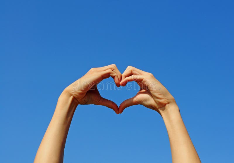 I Love You in Hand Sign Language on Blue Sky Background. Stock Photo