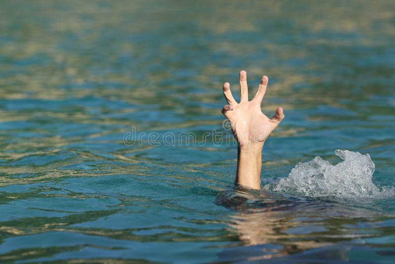 Hand of a man drowning in the sea trying to float