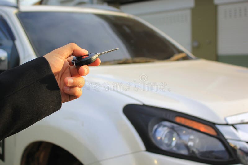 Hand of man holding car remote control pointing to car door open, Car security lock system concept royalty free stock images Hand of man holding car remote control pointing to car door open, Car security lock system concept royalty free stock images