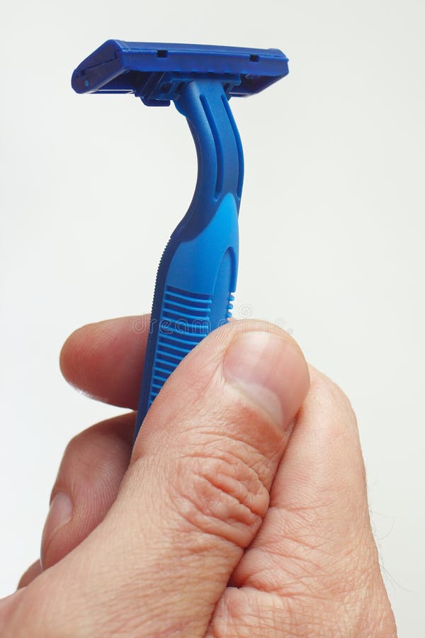 Hand of man holding a razor closeup royalty free stock image Hand of man holding a razor closeup royalty free stock image