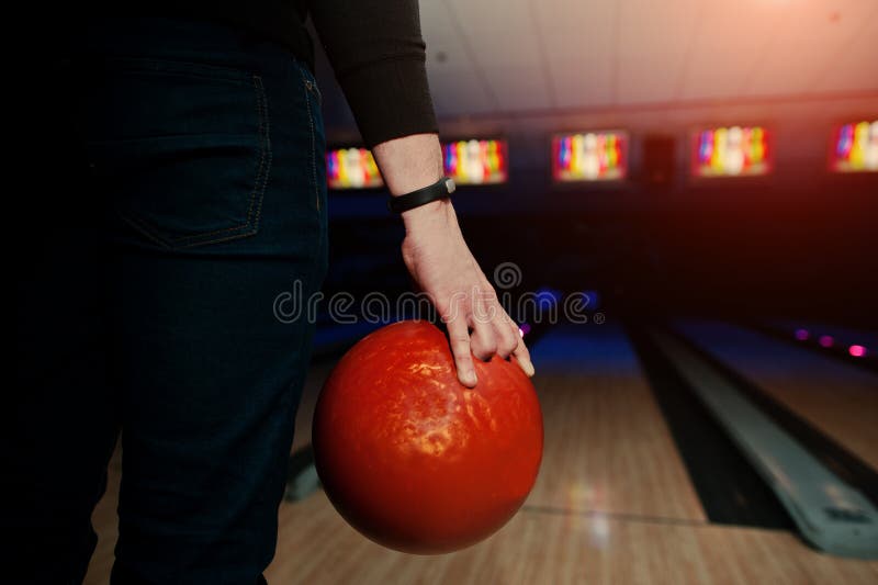 Hand of Man Player with Bracelet Holding Bowling Ball Stock Photo