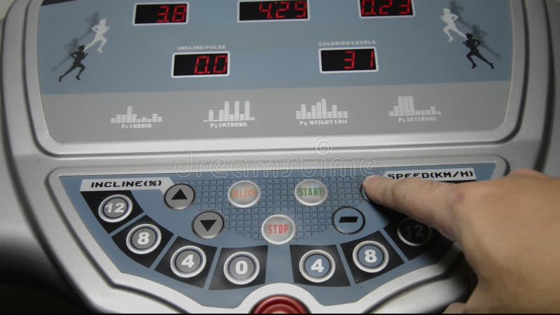 Hand of man setting  increase and decrease speed of a treadmill. Decrease video