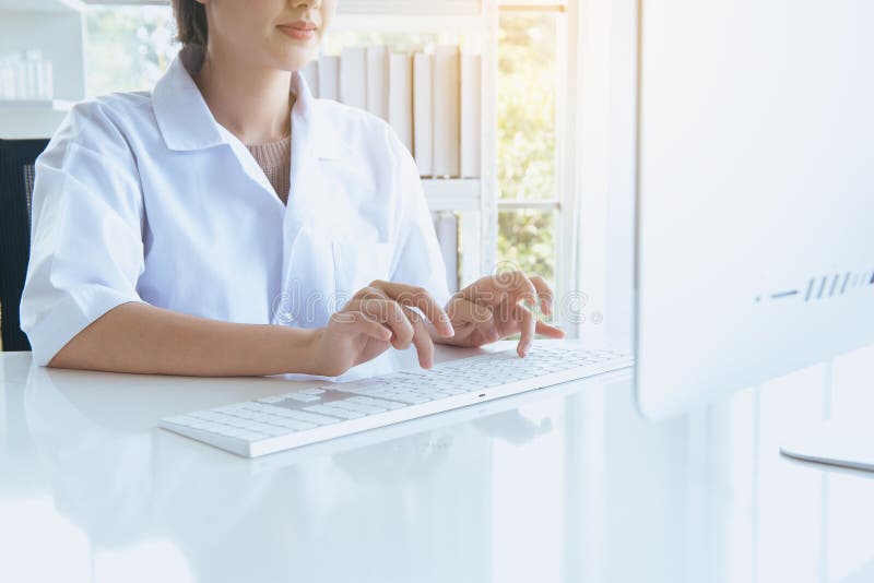 Hand medical student woman using computer keyboard on desk in office room,Finger typing close up