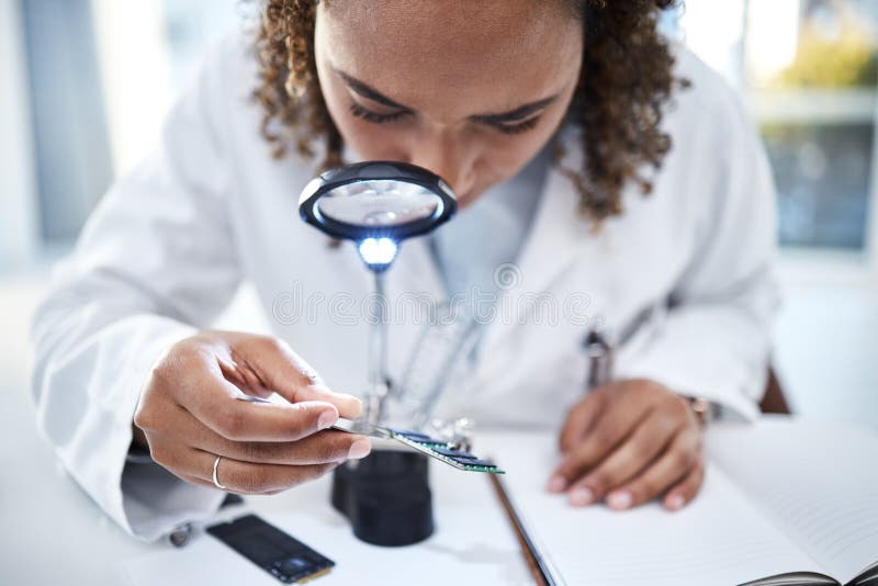Hand, Microchip and Magnifying Glass with an Engineer Woman at Work in