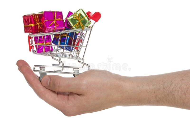 Hand mit dem Warenkorb voll von den bunten Geschenken stockfotografie Hand mit dem Warenkorb voll von den bunten Geschenken stockfotografie