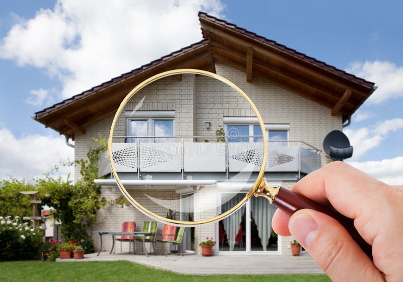 Person Hand With Magnifying Glass Over Luxury House. Person Hand With Magnifying Glass Over Luxury House