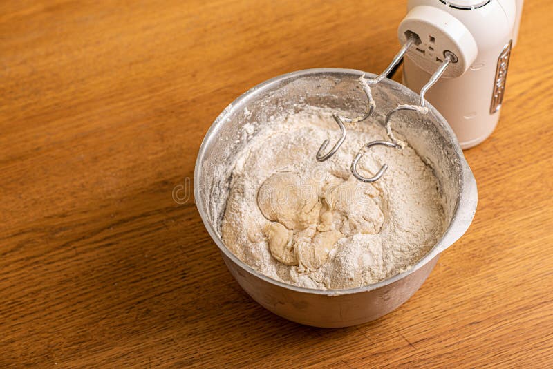 Hand mixer and a metal bowl with dough
