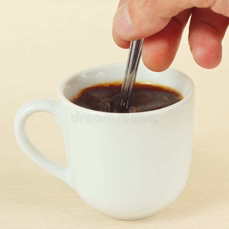 Hand Mixing with a Spoon of Aromatic Coffee in Cup Stock Photo Image