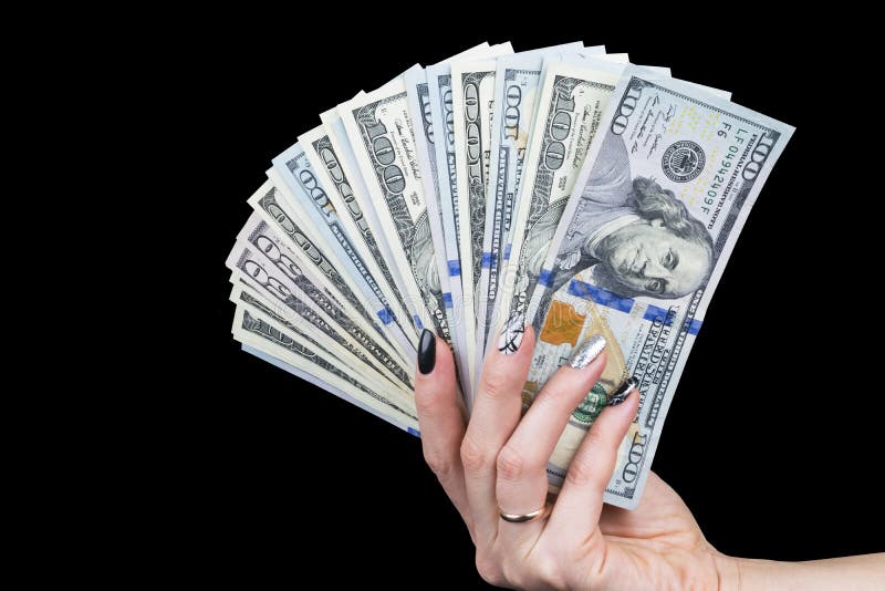 Hand with money isolated on black background. US Dollars in hand. Handful of money. Business woman offering money. Counting money.