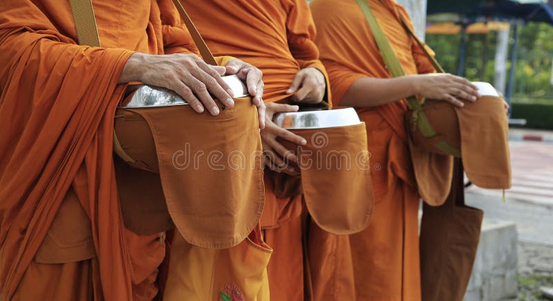HAND OF MONKS HOLDING BOWL royalty free stock photos