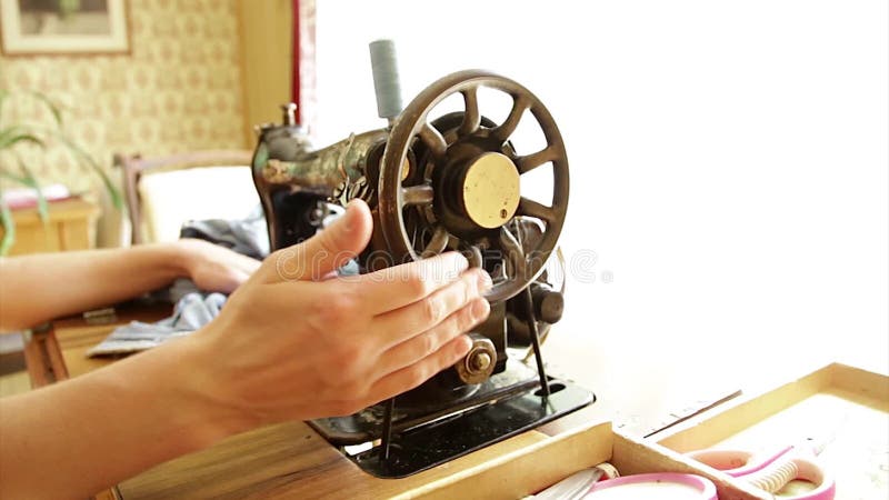 Hand moving rotating vintage sewing machine putting patch stock footage