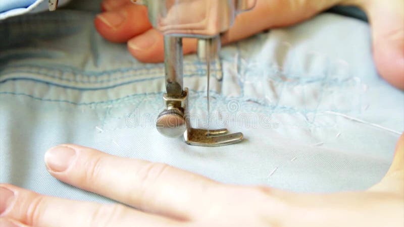 Hand moving rotating vintage sewing machine putting patch stock video