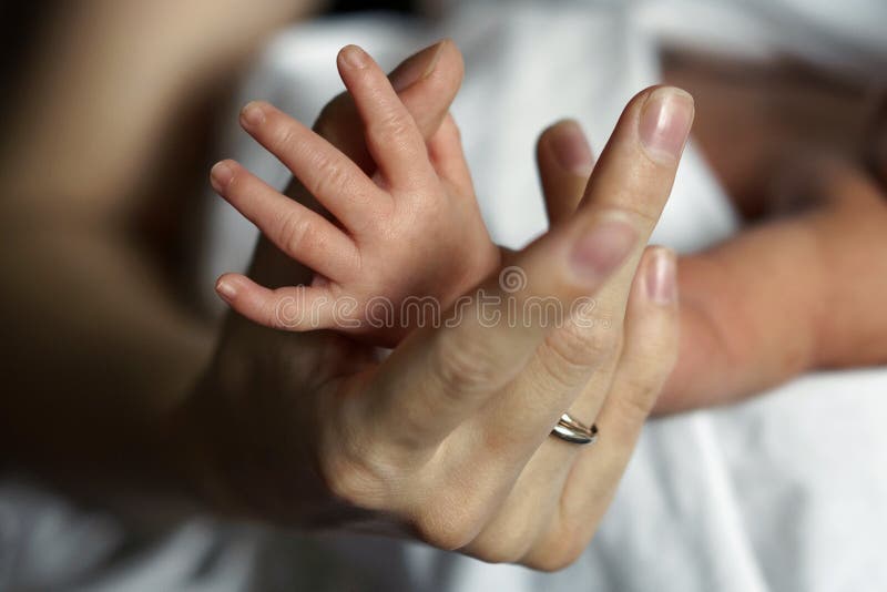 Hand of the newborn in the hand of a woman stock photography Hand of the newborn in the hand of a woman stock photography