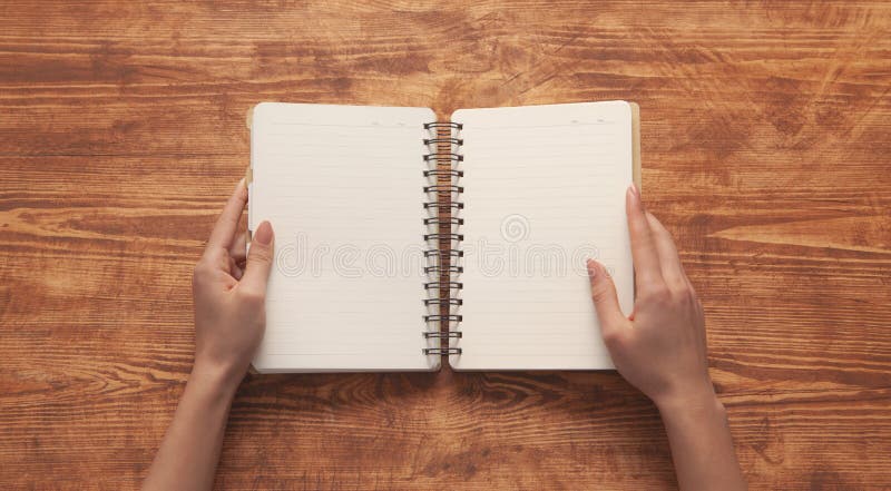 Hand notebook wooden background stock photos
