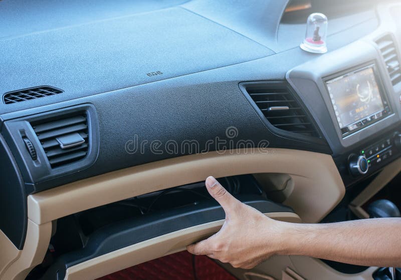 Hand man open glove compartment in car