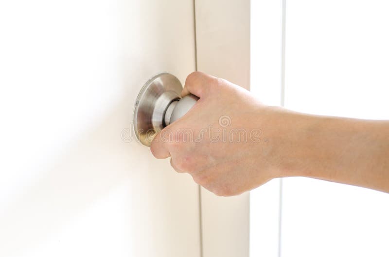 Hand opening door knob,white door royalty free stock photo