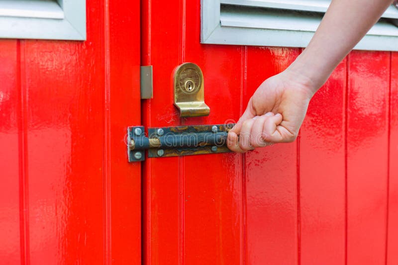 Hand opening little red door stock photography Hand opening little red door stock photography