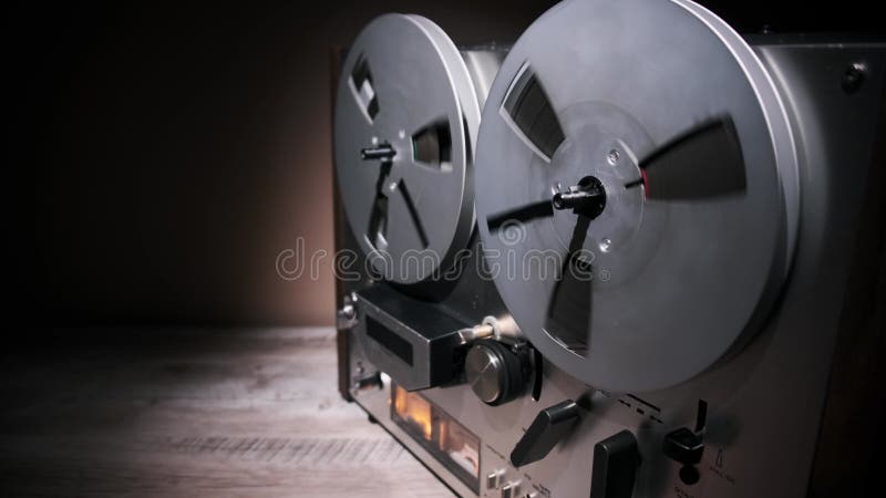 Hand operating vintage reel-to-reel tape recorder stock footage