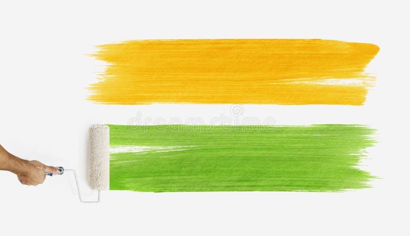 Hand with paint roller painting color orange and green, close up royalty free stock photos Hand with paint roller painting color orange and green, close up royalty free stock photos