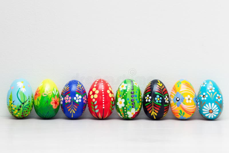 Hand-painted Easter eggs on white rustic wall. Spring patterns stock photography Hand-painted Easter eggs on white rustic wall. Spring patterns stock photography