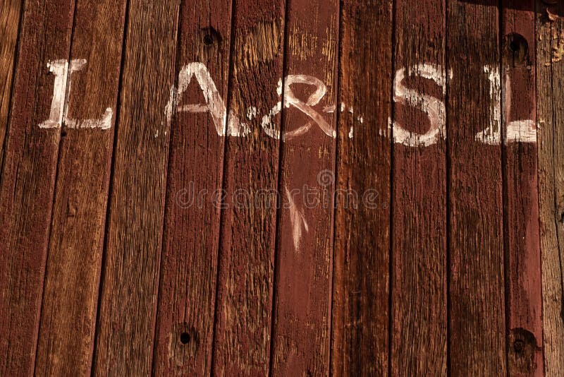 Hand painted white letters on side of abandoned train railroad car caboose exterior