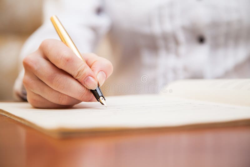 Hand with pen and music sheet