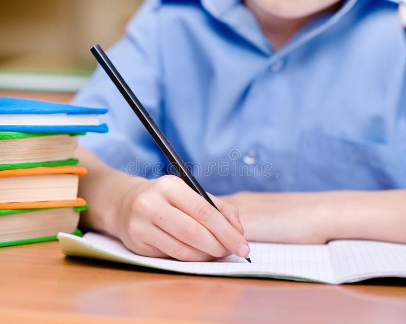 Hand with pencil writing in a notebook stock image Hand with pencil writing in a notebook stock image