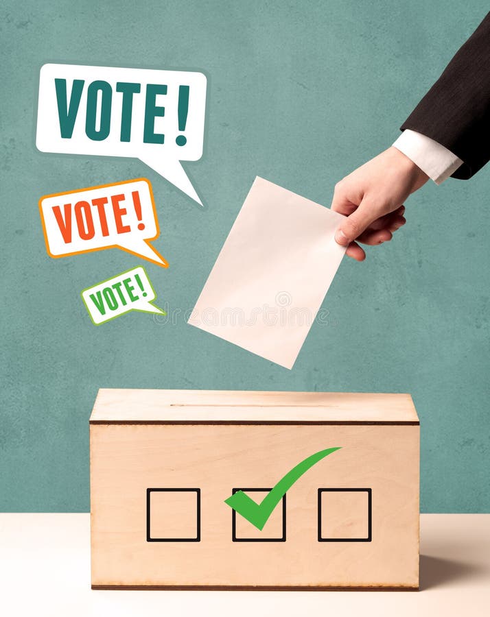 A Hand Placing A Voting Slip Into A Ballot Stock Image Image of