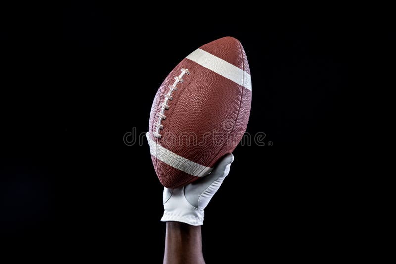 Football Player Holding Football With Both Hands Stock Photo