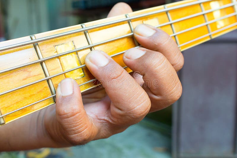 Hand playing bass stock photo. Image of male, sideview 64950254