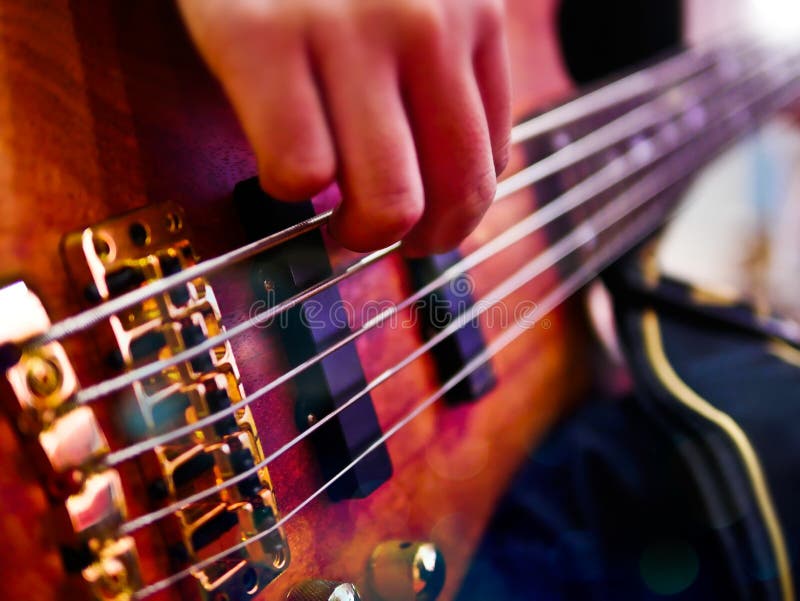 Hand Playing Bass Guitar during a Performance. Stock Photo Image of