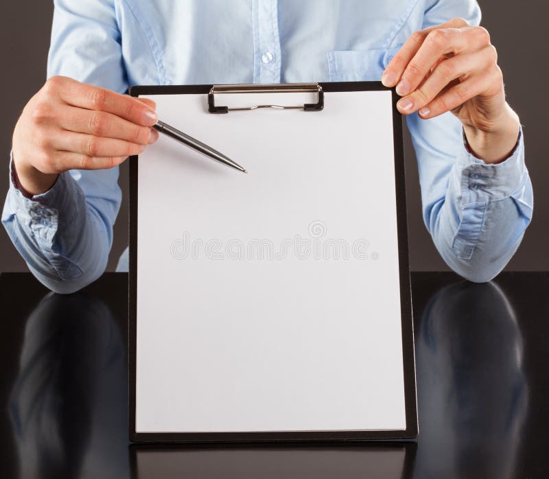 Hand pointing at blank paper in clipboard with a pen