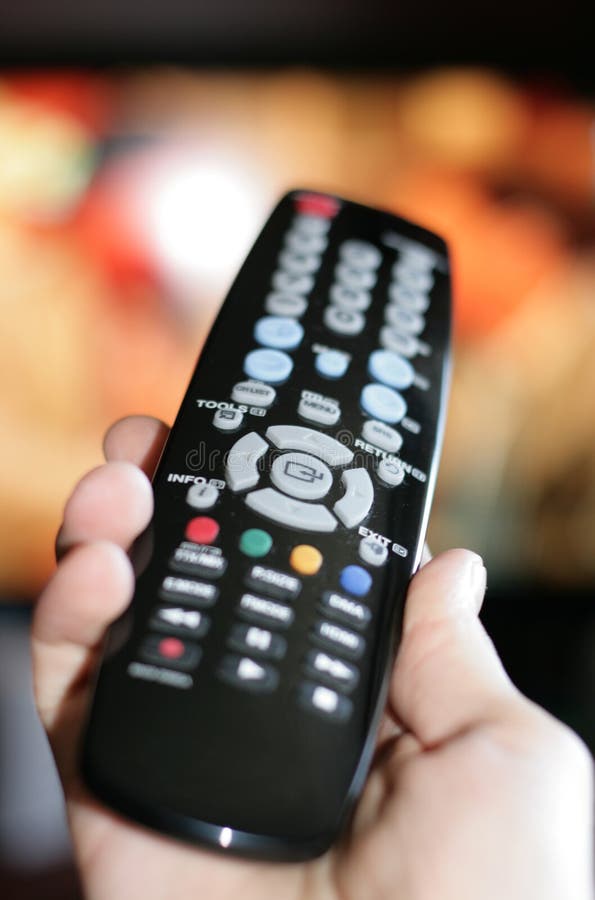 Hand pointing a tv remote control stock photo
