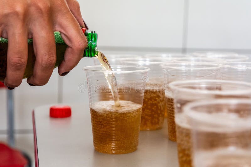 Hand Pouring Beer into Plastic Cups Stock Photo Image of pour, cups