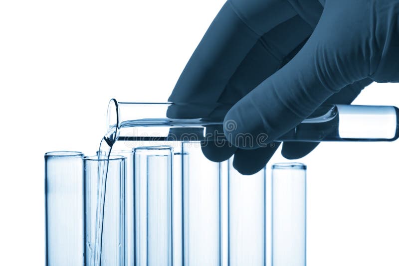Hand pouring liquid into test tube isolated