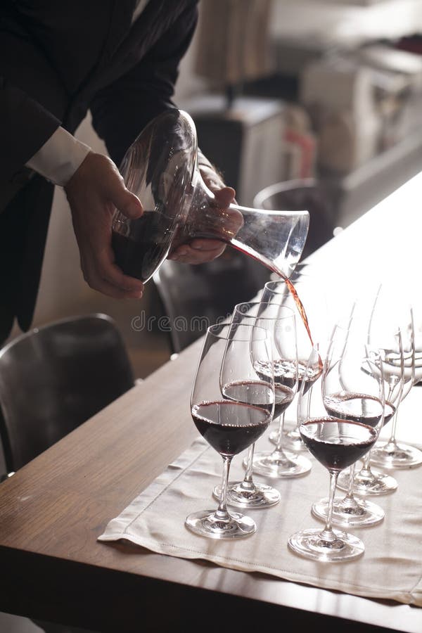 Hand pouring wine stock photo. Image of dining, indoors 33542284