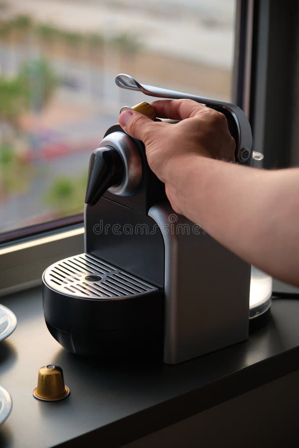 Hand Preparing Coffee in a Coffee Machine with Capsules. Stock Image