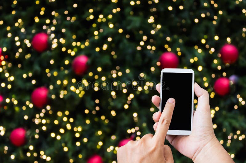 Hand press on big smartphone screen on Xmas New Year theme golden bokeh royalty free stock photos Hand press on big smartphone screen on Xmas New Year theme golden bokeh royalty free stock photos