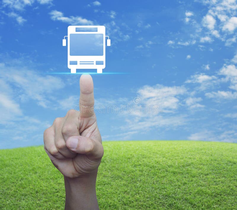 Hand pressing bus flat icon over green grass field with blue sky, Business transportation service concept. Hand pressing bus flat icon over green grass field with blue sky, Business transportation service concept