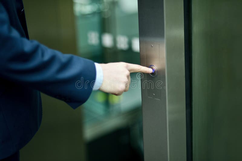 Hand pressing elevator button stock image