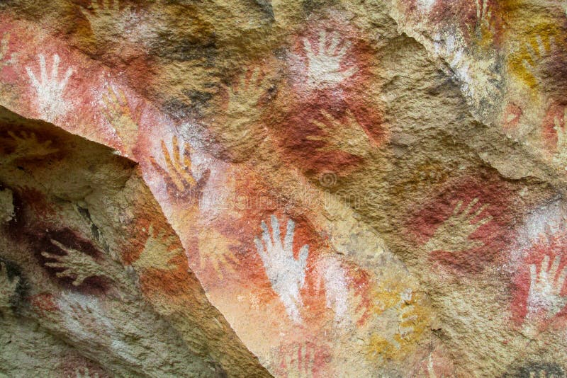 Cave of Hands in Argentina, cueva de las manos. Handprints made with red, yellow and black colour paint of ancient people on the wall of a cave. Cave of Hands in Argentina, cueva de las manos. Handprints made with red, yellow and black colour paint of ancient people on the wall of a cave